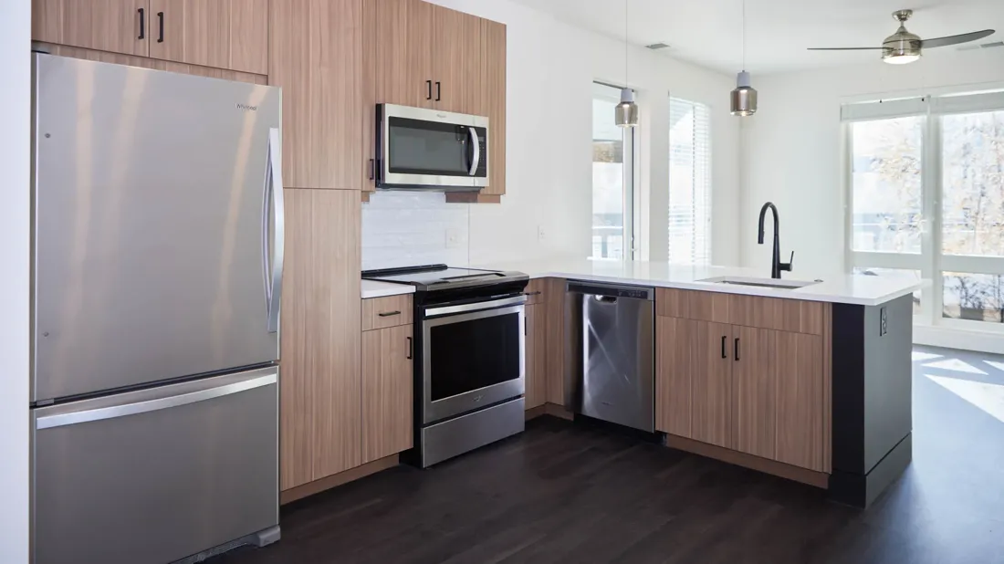 Kitchen cabinetry and peninsula in a finished unit